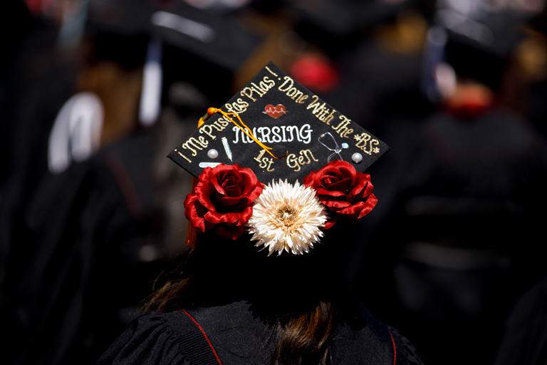 A Spanish-English decorated grad cap from a first-gen nursing student